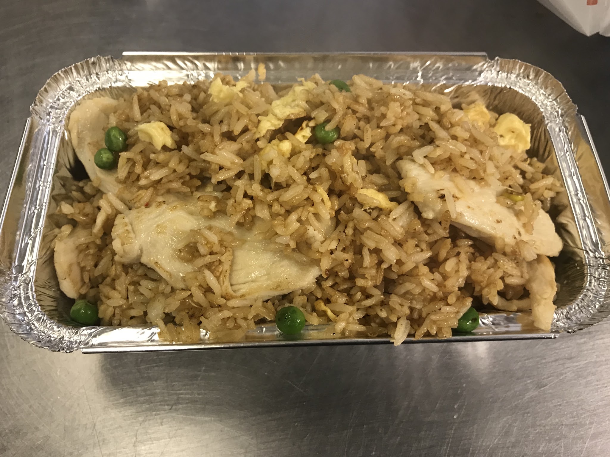 A rice dish served in a takeaway tray