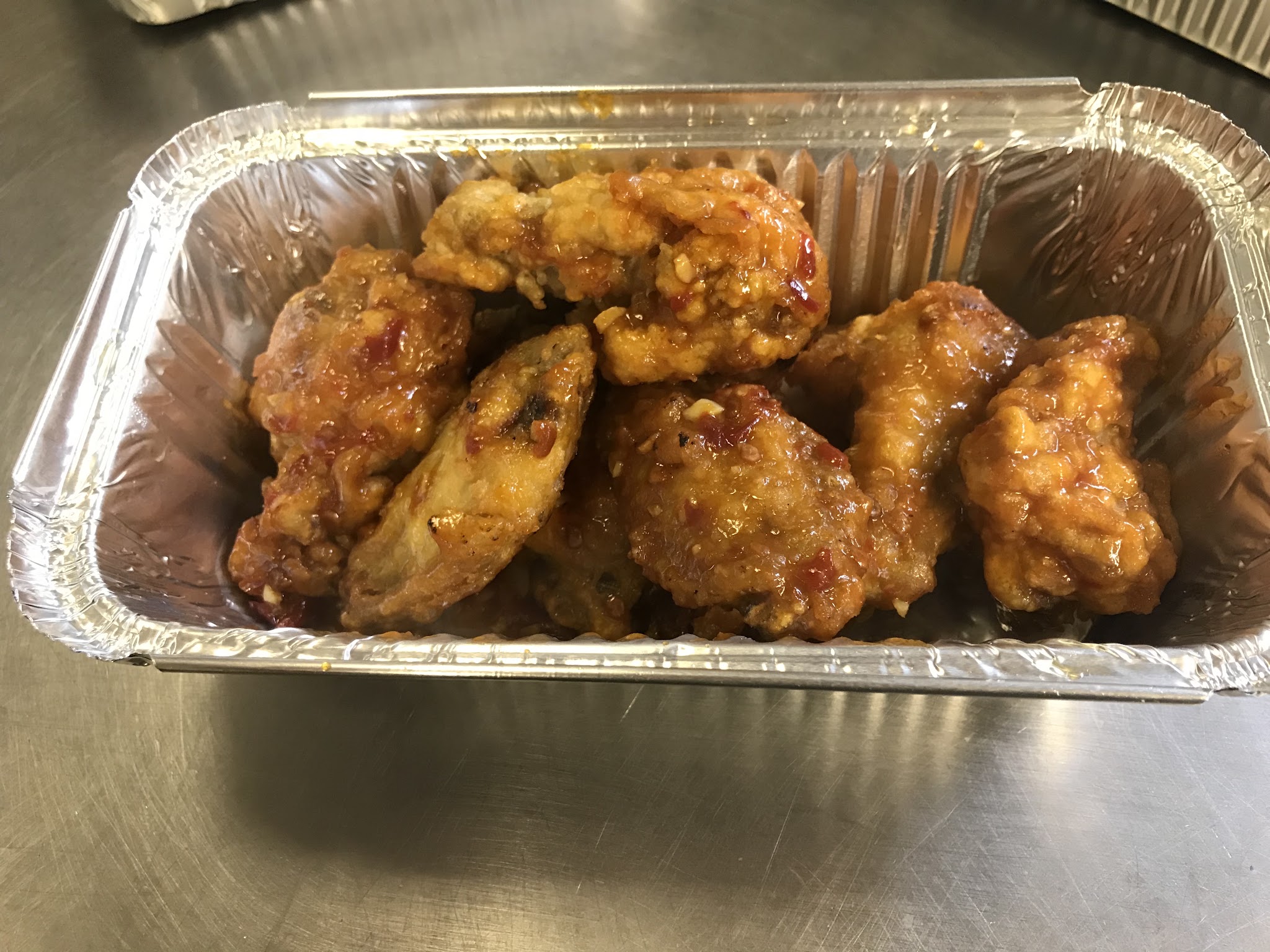 Glazed food served in a takeaway tray